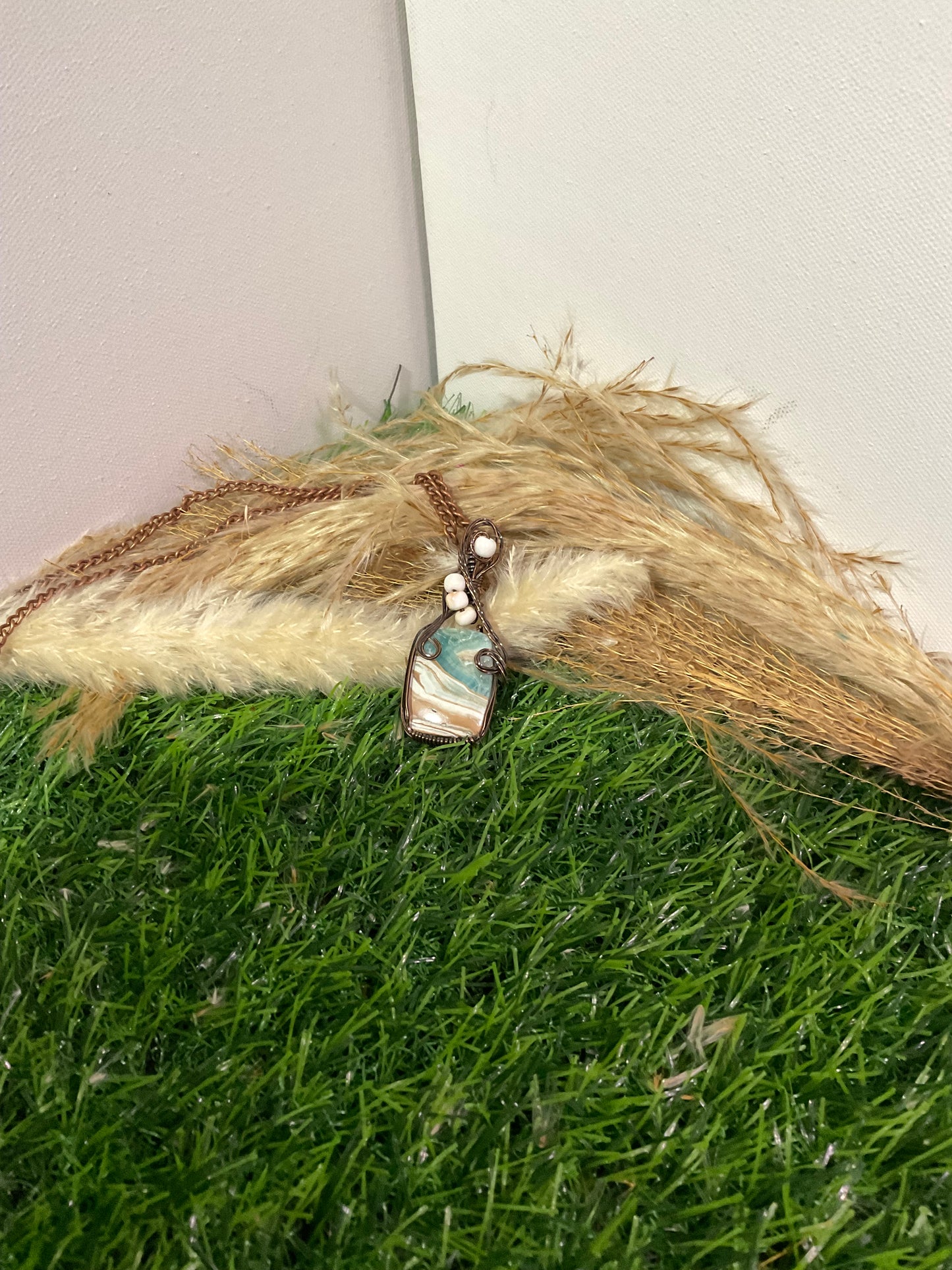 Caribbean Calcite pendant wrapped in oxidized copper
