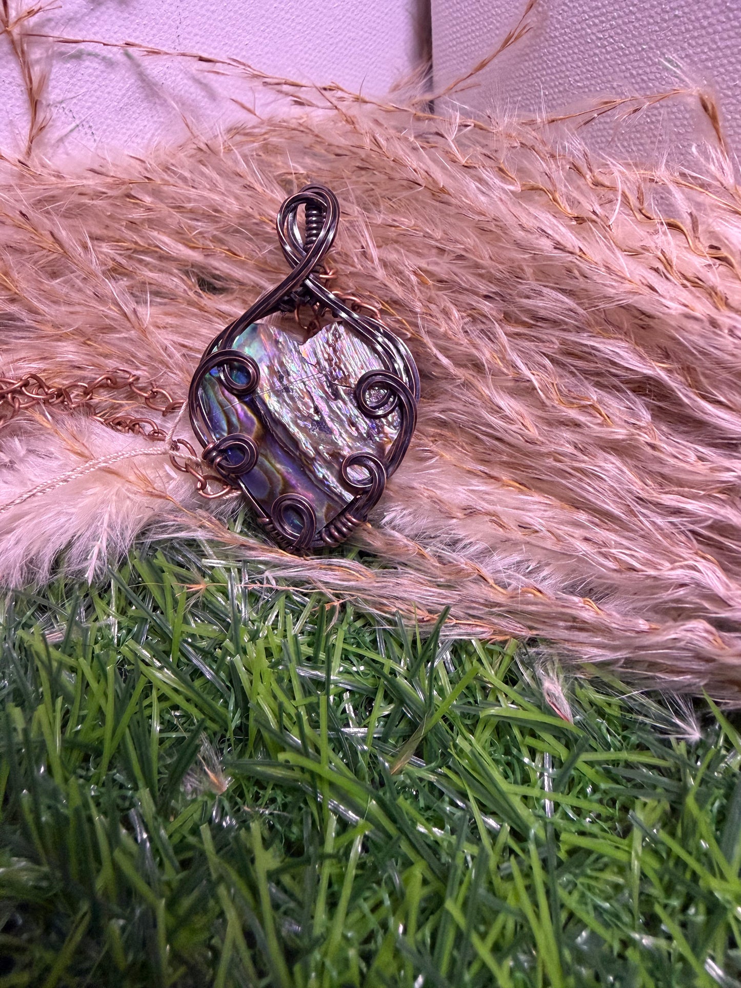 Abalone shell pendant wrapped in oxidized copper