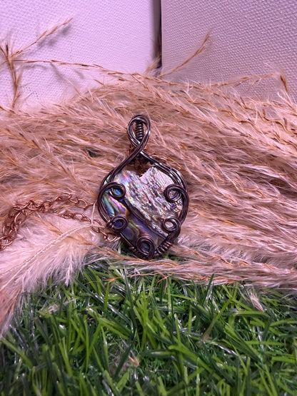 Abalone shell pendant wrapped in oxidized copper