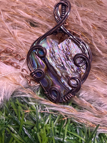 Abalone shell pendant wrapped in oxidized copper