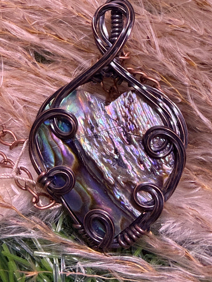 Abalone shell pendant wrapped in oxidized copper