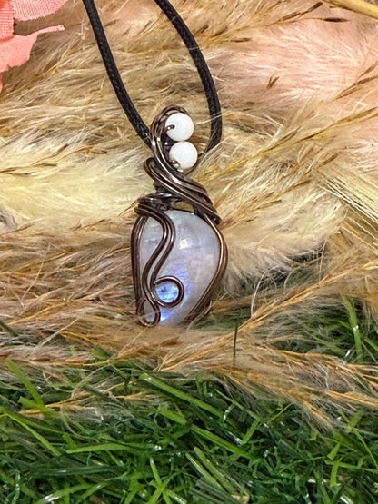 Moonstone pendant wrapped in oxidized Copper