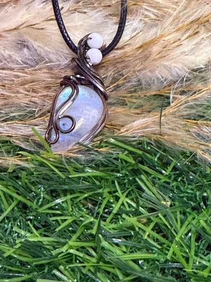 Moonstone pendant wrapped in oxidized Copper