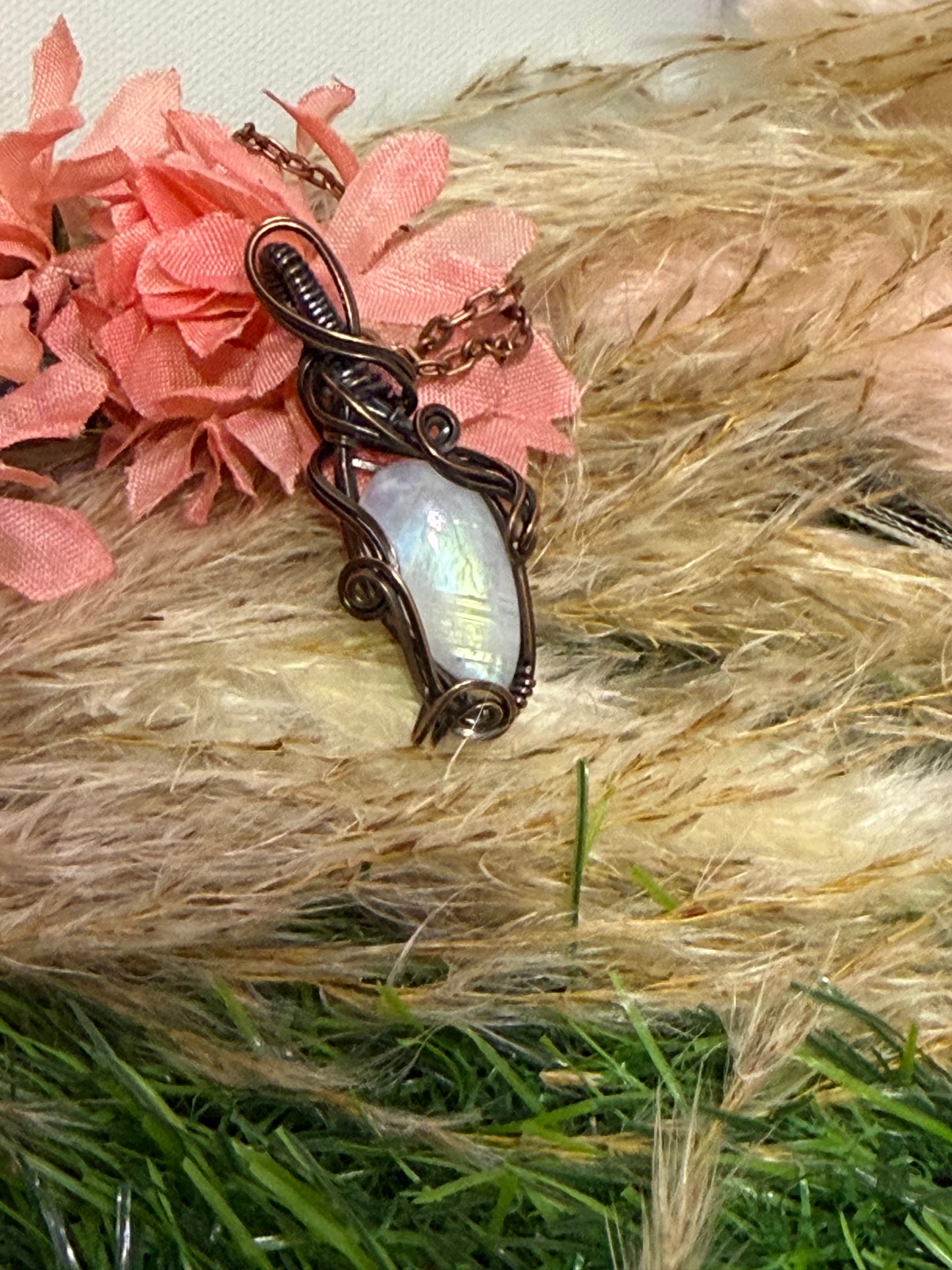 Moonstone pendant wrapped in oxidized Copper