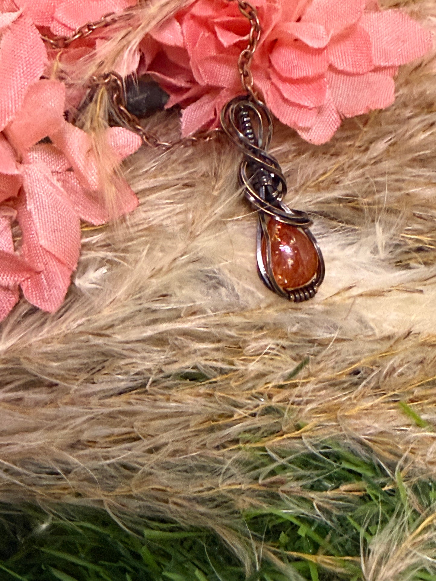 Sunstone pendant wrapped in oxidized copper