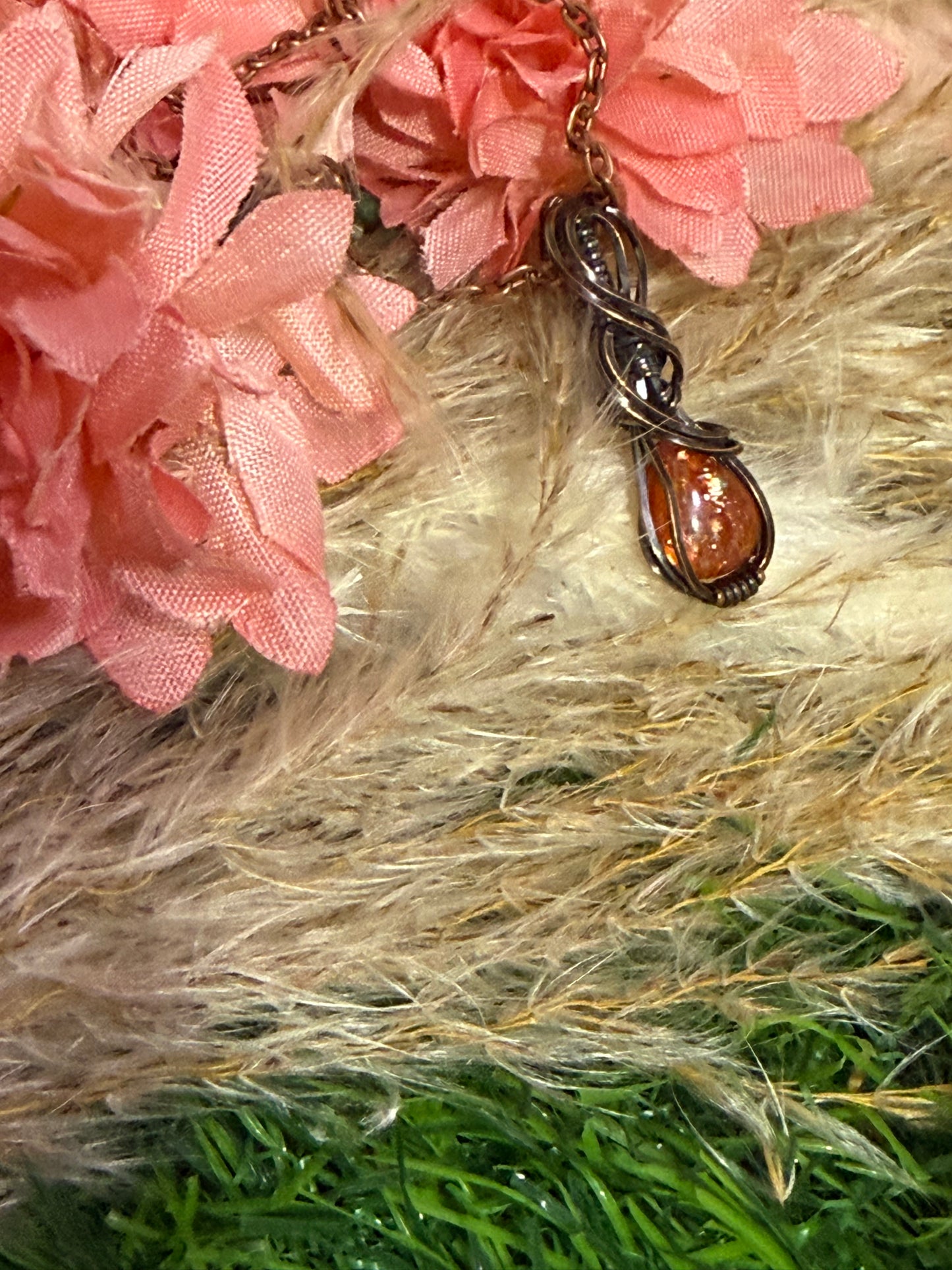Sunstone pendant wrapped in oxidized copper
